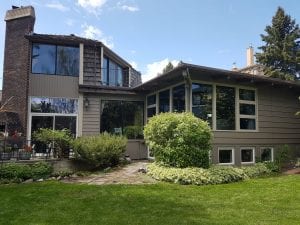 Exterior image of a wood painting project in Calgary | Hotshot Construction
